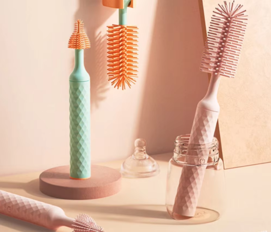 Set of dental cleaning brushes with different bristle designs on a soft pink background
